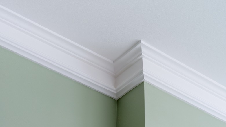crown molding on top of green walls