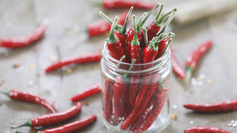 chili peppers in glass jar