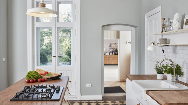 arched doorway to modern kitchen