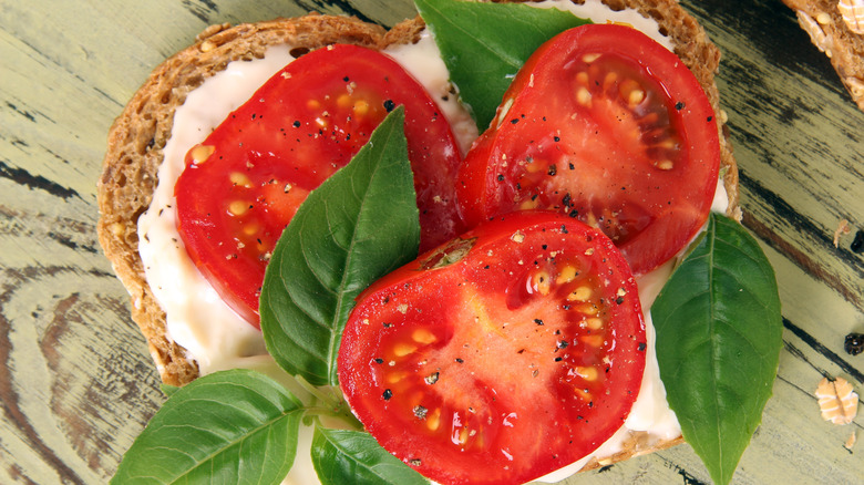 tomatoes and cream cheese on bread