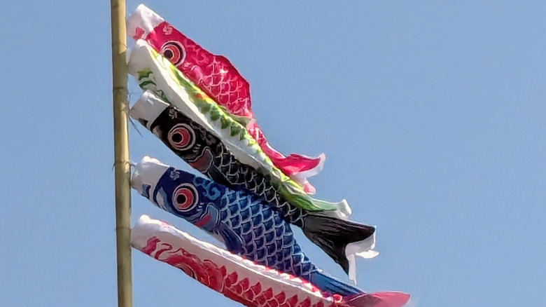 Fish flags on pole flapping in the wind