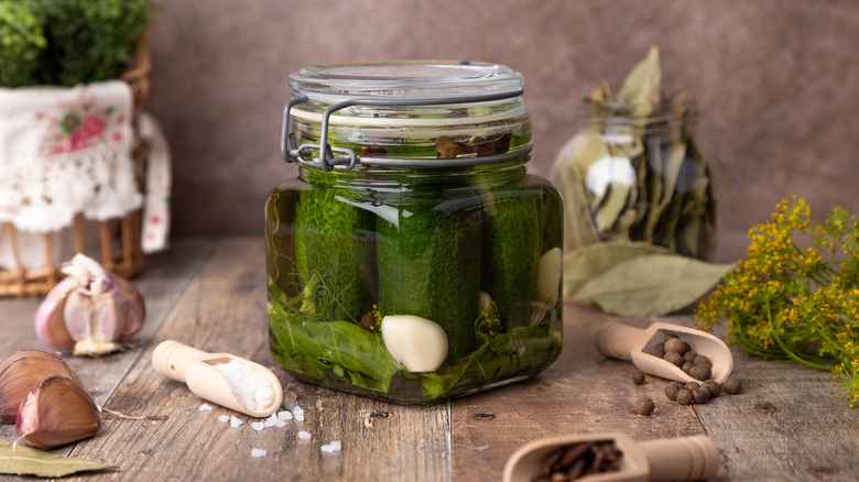 Half-sour pickles in a jar