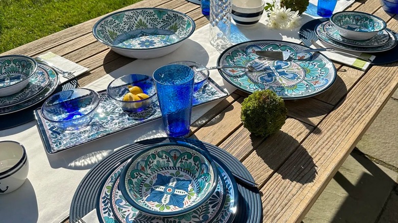 Outdoor table with serving ware set up for entertaining
