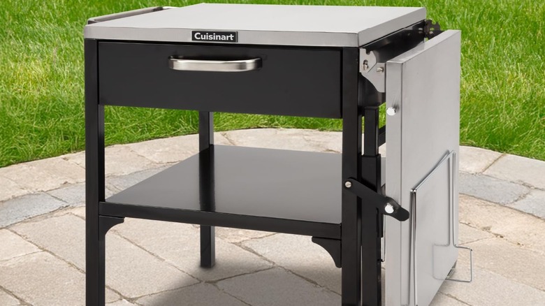 Grill table on a patio with side folded down