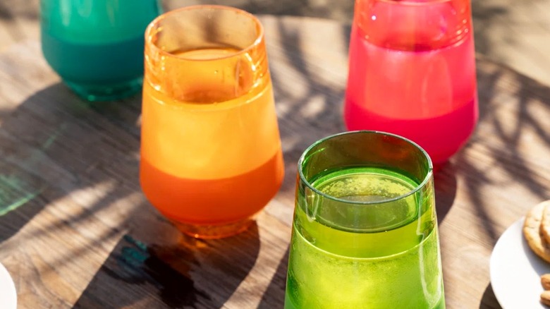 Multiple colorful glasses resting on a table
