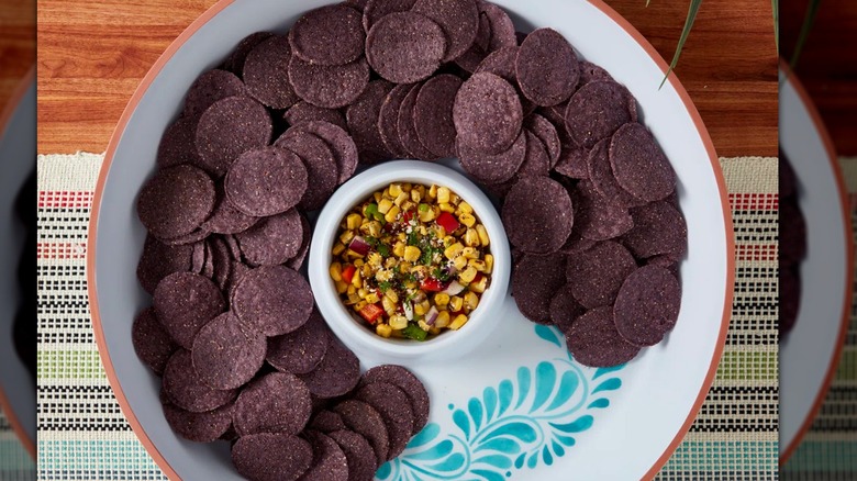 Chips and salsa on a colorful tablecloth