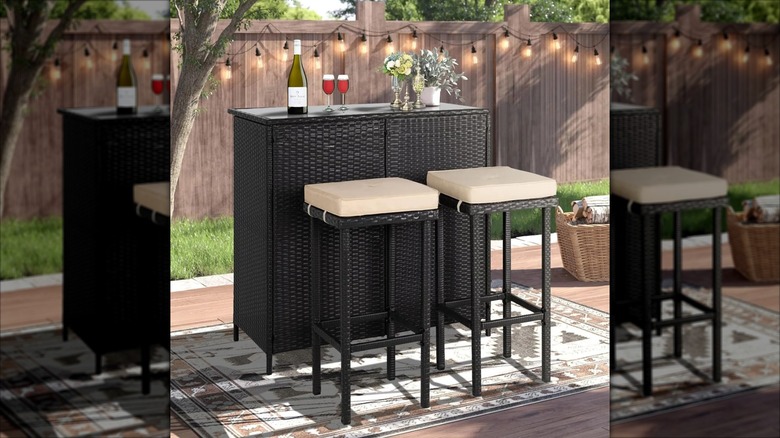Outdoor bar with padded backless stools