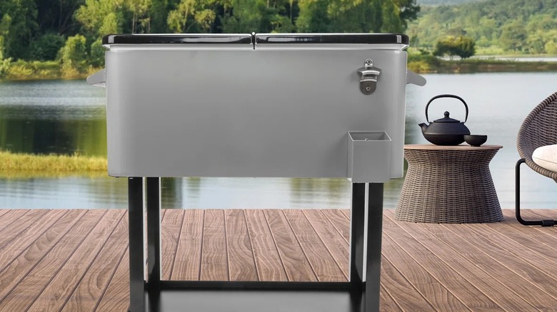 Outdoor cooler on a patio with lake behind it