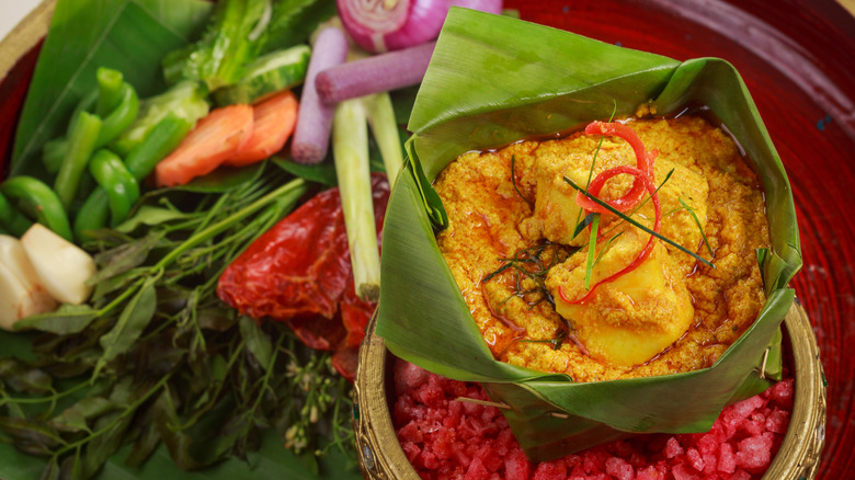 A banana leaf filled with fish amok