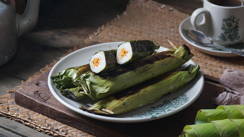 A plate of sticky rice wrapped in banana leaves