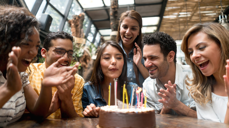 People celebrating a birthday at a restaurant