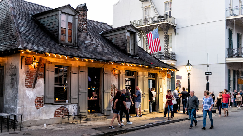 People walking outside Lafitte's Blacksmith Shop Bar in New Orleans, Louisiana