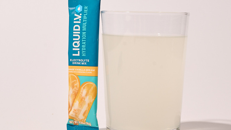 orange vanilla dream liquid I.V. on a table with glass