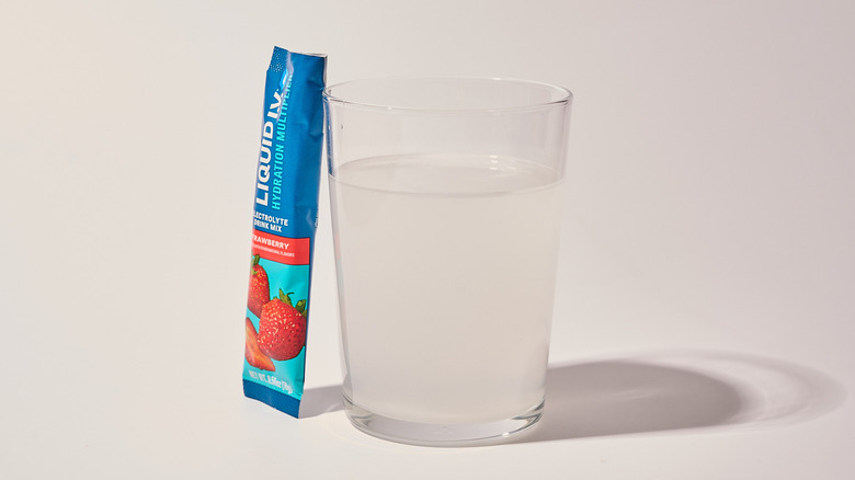 Strawberry Liquid I.V. next to a glass of water