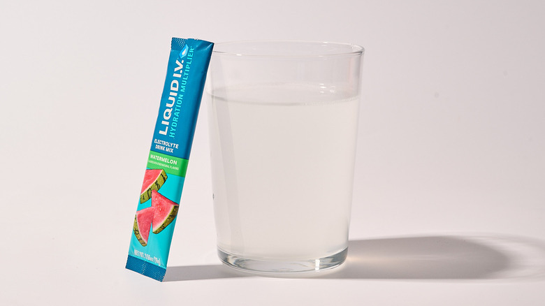 Watermelon Liquid I.V. next to a glass of water