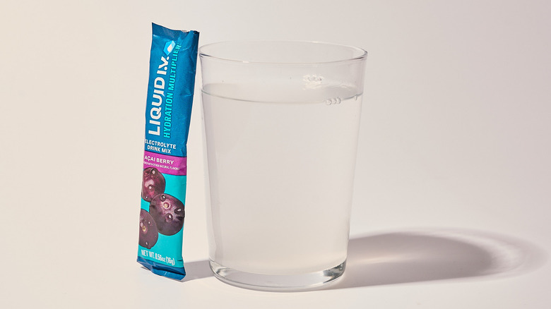 Açai Berry Liquid I.V. next to a glass of water