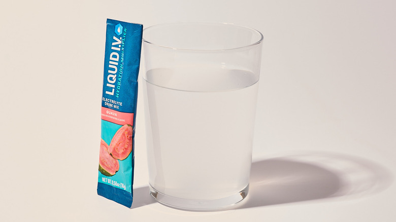 Guava Liquid I.V. next to a glass of water