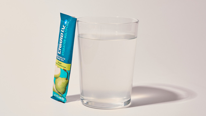 Pear Liquid I.V. next to a glass of water