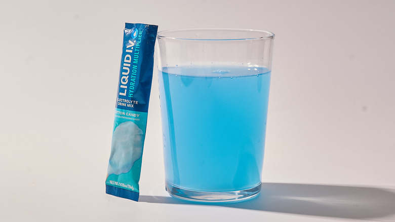 Cotton Candy Liquid I.V. next to a glass of water