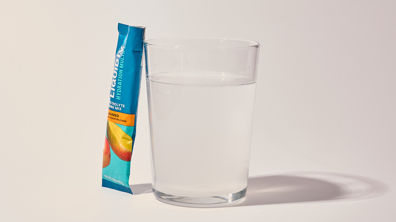 Mango Liquid I.V. next to a glass of water