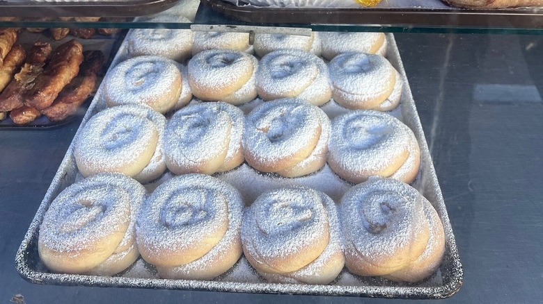 Tray of Mallorca pastries dusted with powdered sugar