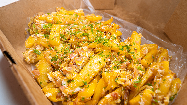 A cardboard takeout container of revuelto gramajo