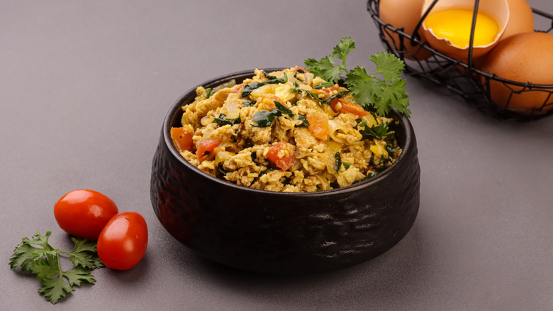 A bowl of Indian anda bhurji on a table