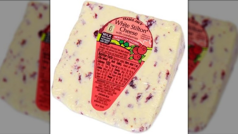 Plastic-wrapped wedge of Trader Joe's White Stilton Cheese with Cranberries