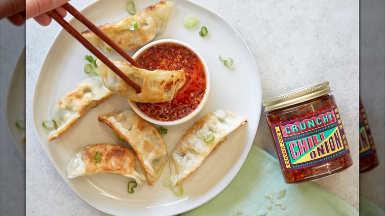 Jar of Trader Joe's crunchy chili onion next to dumplings