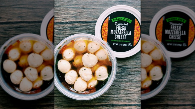 Close up of Trader Joe's marinated fresh mozzarella cheese balls on wood table.