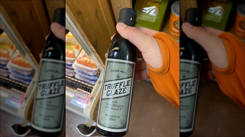 Shopper holding bottle of Trader Joe's truffle balsamic glaze in store.