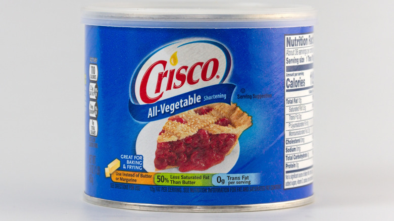 Crisco's trademark packaging set against an off-white background.