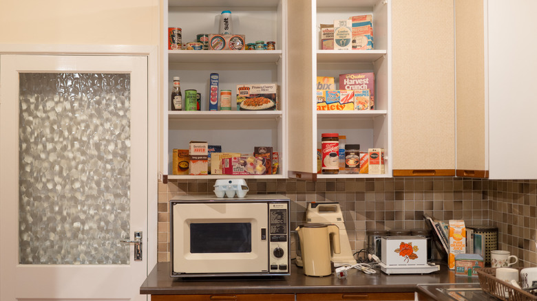 A vintage-looking kitchen featuring a microwave oven