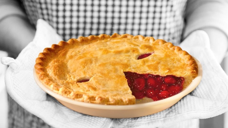 A person holding a Mrs. Smith's cherry pie