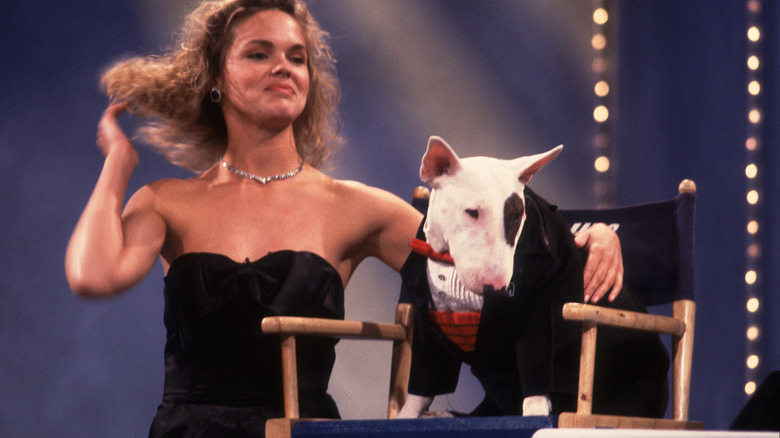 Spuds Mackenzie in a tuxedo during a television interview along with a woman.