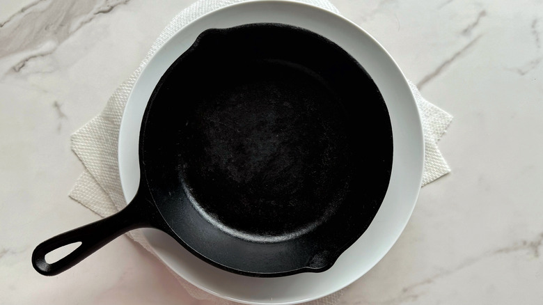 cast iron skillet set over plate