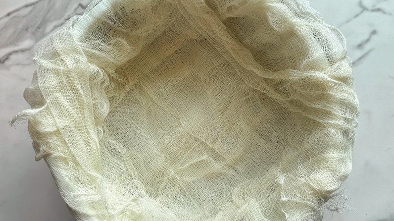 bowl lined with colander and cheesecloth