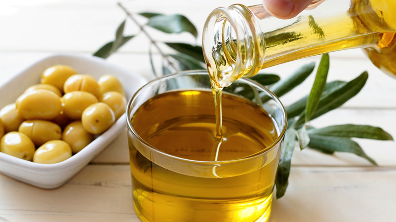 olives and olive oil on a white table