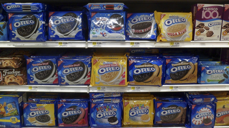 Grocery store shelves with boxes of different flavors of Oreos