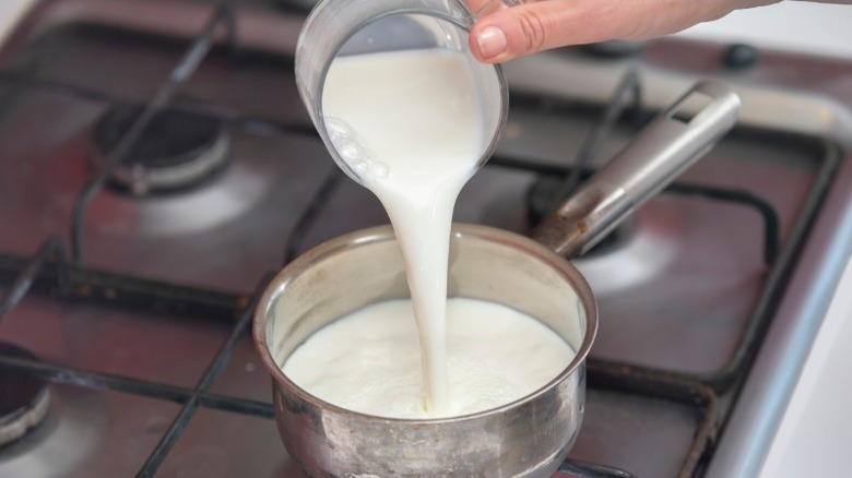 Adding milk to béchamel sauce