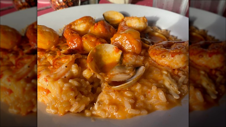White bowl of Risotto Frutti di Mare Delle Marche