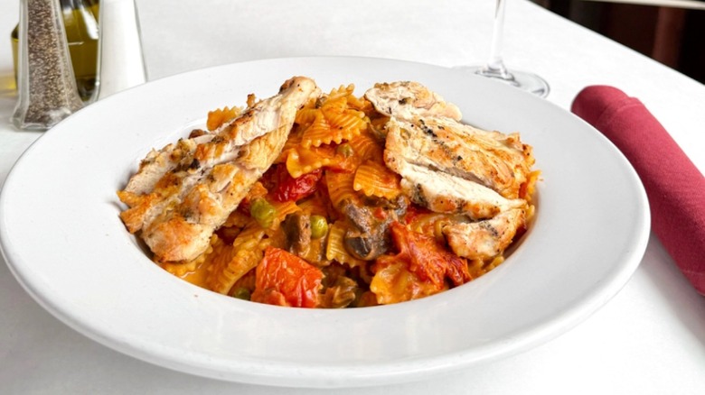 Plate of chicken with farfalle pasta in a tomato sauce