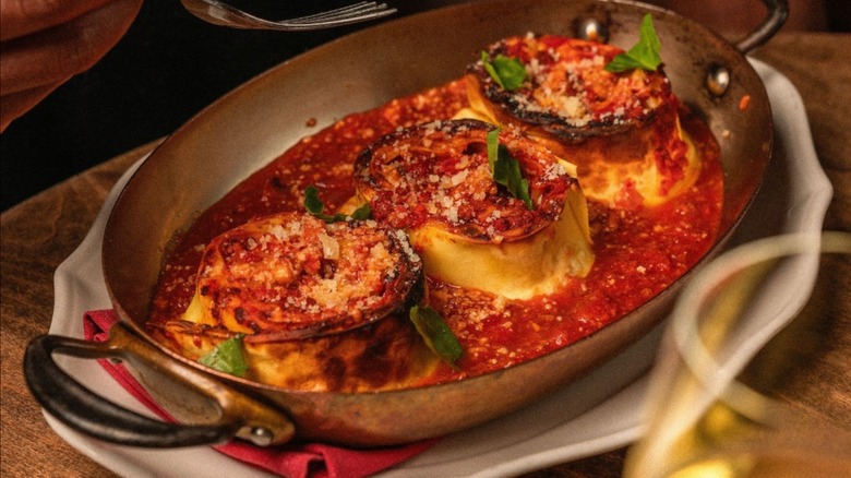 Pan of Sicilian stuffed artichokes in tomato sauce