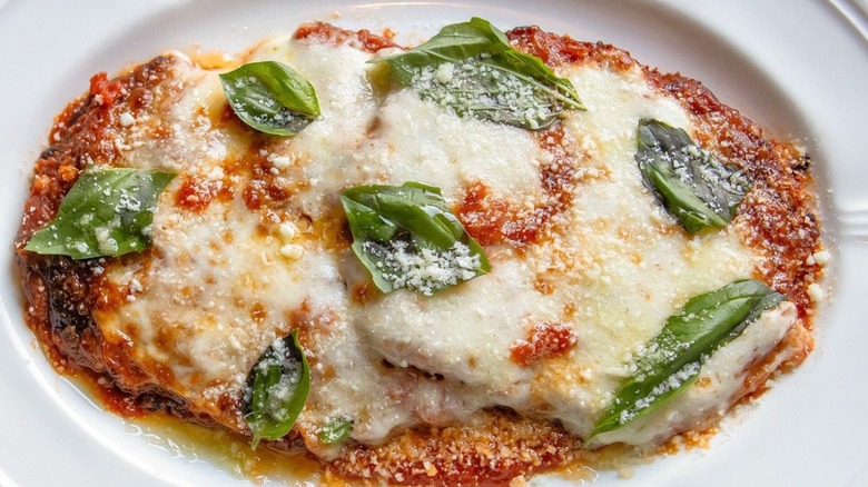 Platter of chicken parmesan with fresh basil