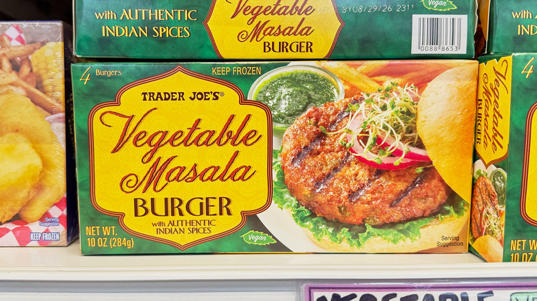Packages of vegetable masala burgers on a shelf at Trader Joe's