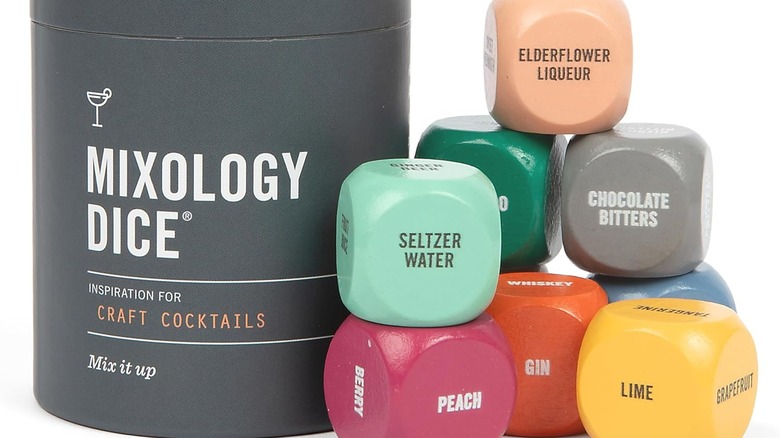 Mixology dice container and colorful dice labeled with ingredients to help players create drinks.