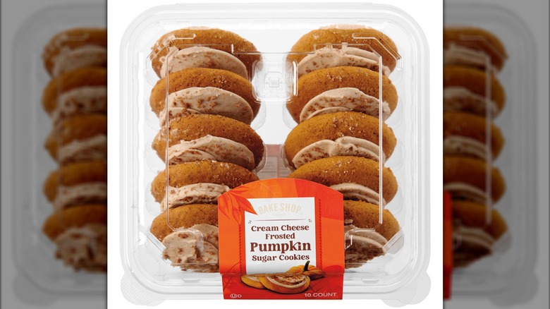 Clamshell container of Bake Shop Cream Cheese Frosted Pumpkin Sugar Cookies.