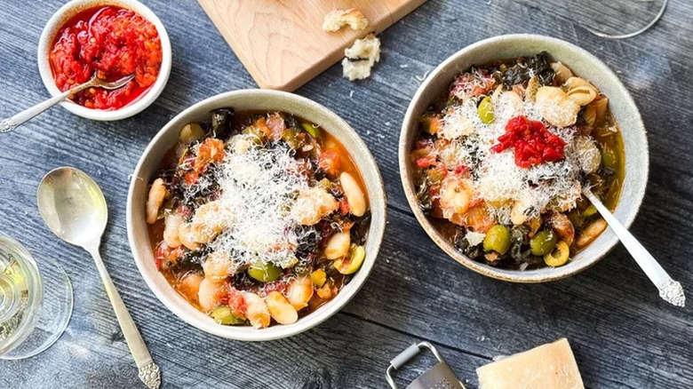 Two bowls of Italian-Style Butter Beans with a small dish of tomato paste in the background
