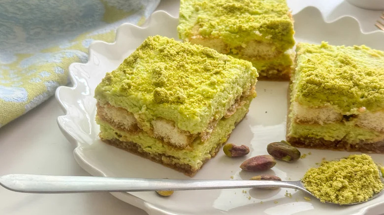 Pistachio Tiramisu on a white plate with pistachio crumb