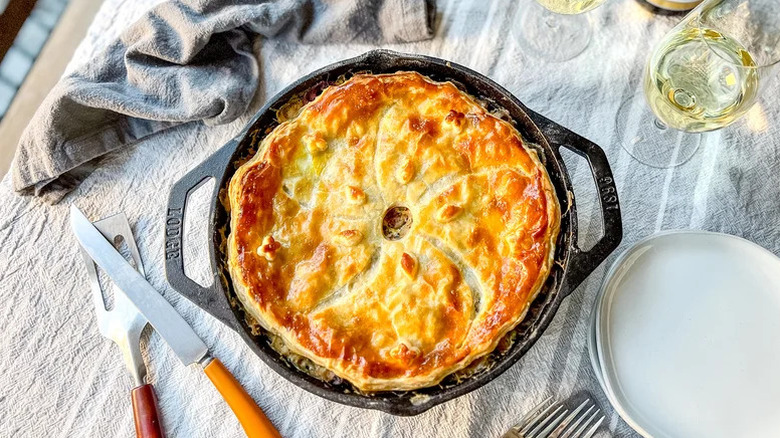 A cast iron pan of Springy Vegetarian Pot Pie with a golden brown crust